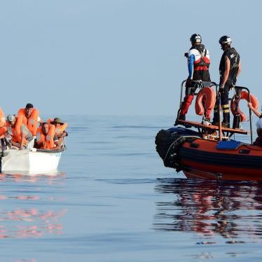 Migrants are seen on board a fiberglass boat in the Mediterranean Sea, off the Libyan Coast, August 12, 2018.