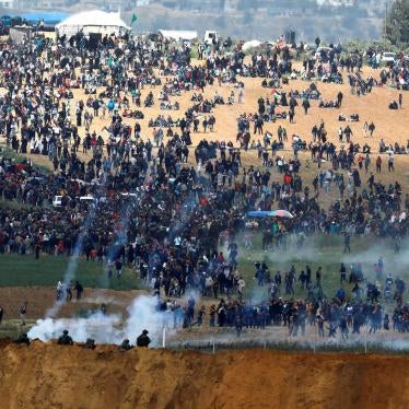 Israeli forces fire tear gas towards Palestinian demonstrators near the fences separating Gaza and Israel, as seen from the Israeli side, on March 30, 2018. © 2018 Reuters