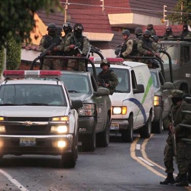 A military convoy protects the vehicle of the Forensic Service which allegedly carries the remains of Ignacio 'Nacho' Coronel in Guadalajara on July 30, 2010. 