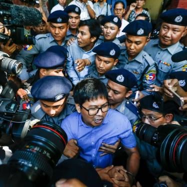 Reuters journalists Wa Lone and Kyaw Soe Oo are escorted by police as they leave the courthouse after a hearing in Yangon, Myanmar, January 10, 2018.
