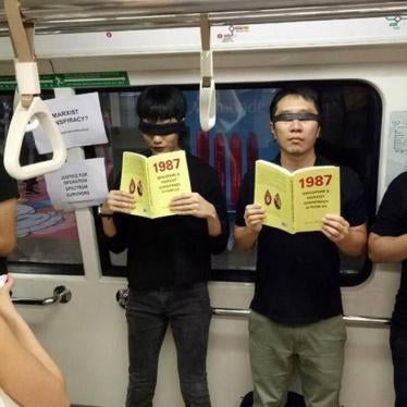 Jolovan Wham participates in a silent protest with eight other activists on an MRT train in Singapore, June 3, 2017