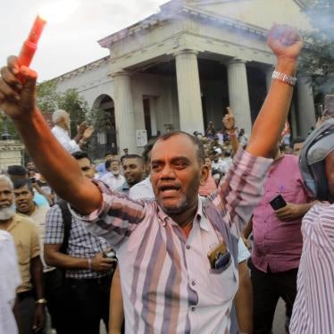 Supporters of ousted Sri Lankan Prime Minister Ranil Wickremesinghe celebrate outside the Supreme Court complex in Colombo after the court unanimously ruled that President Maithripala Sirisena's order to dissolve Parliament was unconstitutional, December 