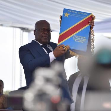 Felix Tshisekedi holds up the constitution after being sworn into office as president of the Democratic Republic of Congo, in Kinshasa, January 24, 2019.