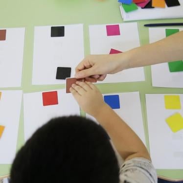 A special education teacher and a child with autism match squares at Balama Center, an organization that offers support to children with autism in Almaty, Kazakhstan. 