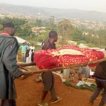 Men carry a dead body for burial in the North-West region village of Meluf, Cameroon, after government forces killed five civilian men on April 4, 2019.
