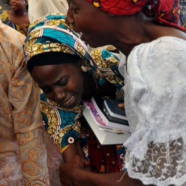 One of the kidnapped Chibok girls celebrates with a family member following her release in Abuja, Nigeria, Sunday, Oct. 16, 2016.