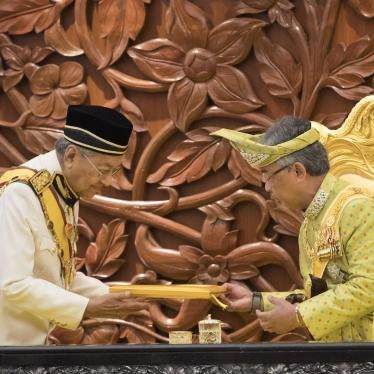 Malaysia's Prime Minister Mahathir Mohamad, left, passes the opening speech to King Sultan Abdullah Sultan Ahmad Shah during the opening of the 14th parliament session at the Parliament House in Kuala Lumpur, Malaysia, Monday, March 11, 2019. 