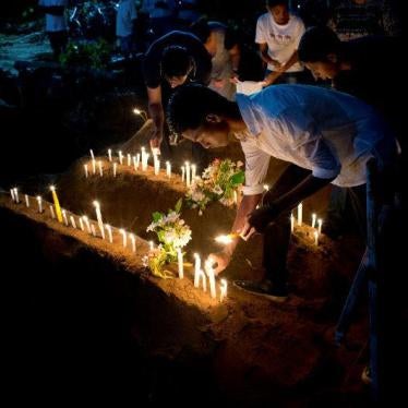 Relatives light candles after burial of three victims of the same family, who died at Easter Sunday bomb blast at St. Sebastian Church in Negombo, Sri Lanka, Monday, April 22, 2019.