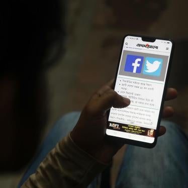 A Bangladeshi reads a news report that makes mention of Facebook along with other social networking service, on his mobile phone in Dhaka, Bangladesh, Thursday, Dec. 20, 2018. 