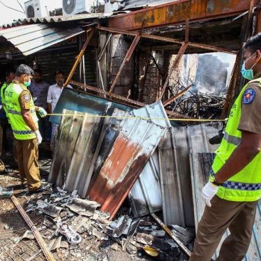Sri Lankan security officers inspect vandalized shops owned by Muslims in Minuwangoda, a suburb of Colombo, Sri Lanka, Tuesday, May 14, 2019. 