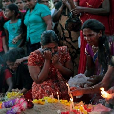 Women mourn at the graves of their relatives who died in 2009 during the last days of the war in Mullivaikkal, Sri Lanka, May 18, 2015.