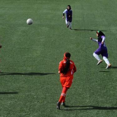 Afghan female football players from Isteghlal (in purple) and Afghan (red) compete during the women's football tournament final match in Kabul on December 6, 2013. 