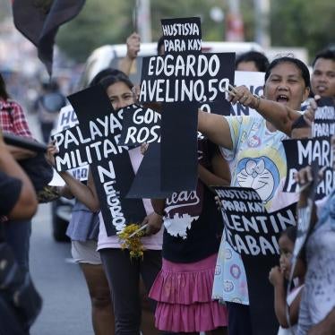 Supporters shout slogans as they hold paper crosses bearing names of killed people from Negros Oriental province during a rally in metropolitan Manila, Philippines on Monday, April 8, 2019.