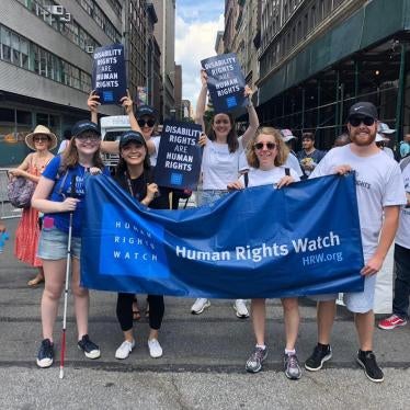 Human Rights Watch staff holds posters reading "Disability Rights are Human Rights" as they march in the Disability Pride Parade in New York City. 