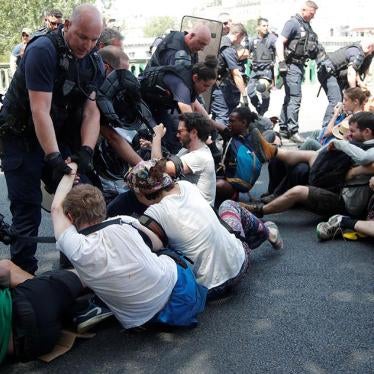 French CRS riot police forcibly remove French youth and environmental activists as they block a bridge during a demonstration in Paris, France.