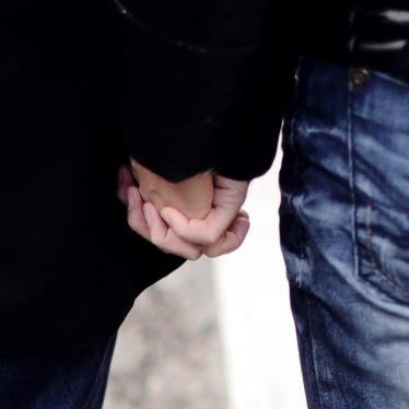 A same-sex couple holds hands