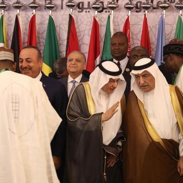 Secretary General of the Organisation of Islamic Cooperation (OIC), Yousef bin Ahmed al-Othaimeen (C), and Saudi Arabia's Foreign Minister Ibrahim Al-Assaf (R) talk before a photo during a meeting of Islamic and Arab foreign ministers in Jeddah on