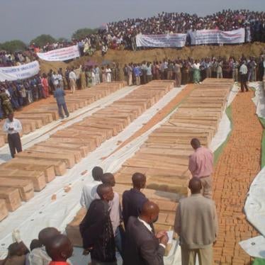 Mourners gather on August 16, 2004, around the coffins of more than 150 Congolese Tutsi massacred at Gatumba, a United Nations-run refugee camp in Burundi.