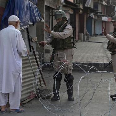 A Kashmiri man is stopped before being allowed to pass near a temporary checkpoint set up by Indian paramilitary soldiers during lockdown in Srinagar,  Friday, August 23, 2019. 