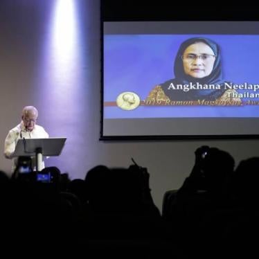 Jose L. Cuisia Jr., chairperson of Ramon Magsaysay Award Foundation, presents the 2019 Ramon Magsaysay awardee Angkhana Neelapaijit from Thailand during an event in Manila, Philippines, Friday Aug. 2, 2019. 