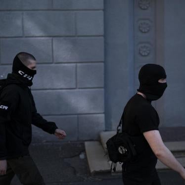 Members of the C14 far right group, some of them wearing balaclavas, march toward an Russian orthodox church in Kiev, Ukraine