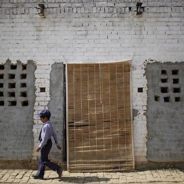 A boy passes by a classroom in a school in Qutbal, Pakistan.