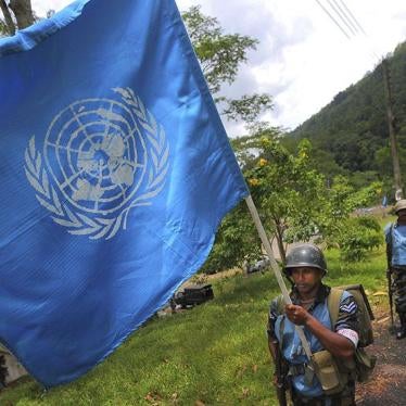 A Sri Lanka Air Force airman carries the UN flag during training for a road patrol at the Institute of Peace Support Operations Training in Kukuleganga, Sri Lanka.
