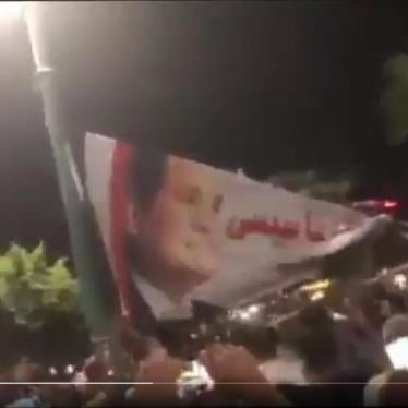 A still photo of a video circulated on social media on September 20 showing masses of anti-government protesters in the city of Damietta, North of Cairo, tearing down a big Sisi banner. © Twitter