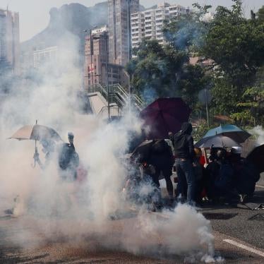 Protesters react from tear gas during a demonstration on China's National Day, under Lion Rock Hill, in Wong Tai Sin, Hong Kong, China October 1, 2019. 