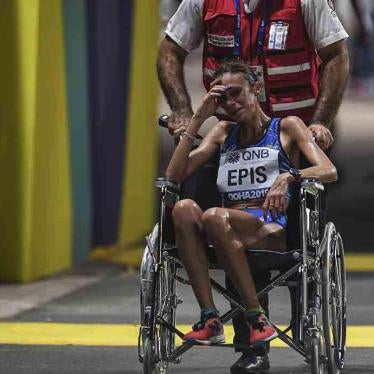 Italy's Giovanna Epis is pushed in a wheelchair during the women's marathon at the World Athletics Championships, in Doha, Qatar.