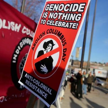 Signs calling for the abolition of Columbus Day stating Genocide is Nothing to Celebrate