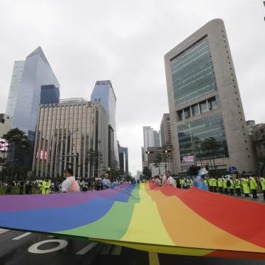 Participants march with a rainbow flag during a gay pride parade in Seoul