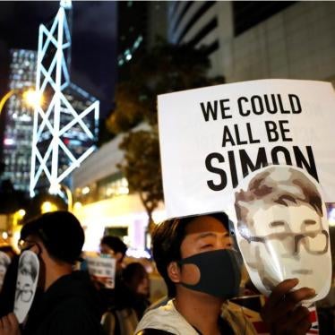 A protester holds a sign reading "We could all be Simon" in reference to Simon Cheng, a Hong Kong British Consulate employee who was detained in China, during a rally outside of the British Consulate in Hong Kong, November 29, 2019. 