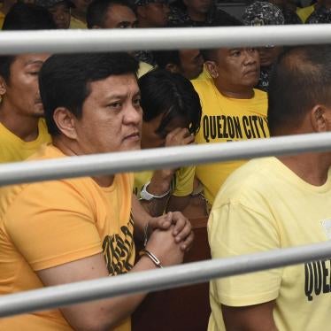 Andal Ampatuan Jr., left, a former town mayor who oversaw and led the Maguindanao Massacre, waits with co-accused at a court inside a prison facility at Camp Bagong Diwa, Taguig city, Metro Manila, Philippines