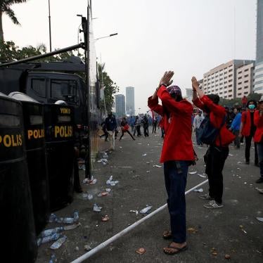 University students gesture in front of police officers during a protest against the draft criminal code in Jakarta, Indonesia, September 24, 2019.