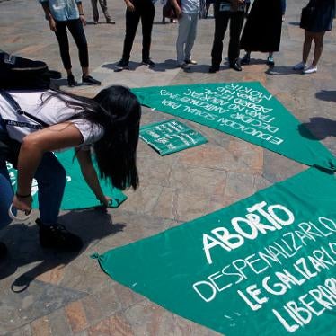 Women organize green cloth banners to be placed on sculptures of Colombian artist Fernando Botero during a protest in Medellin, Colombia on September 28, 2019.