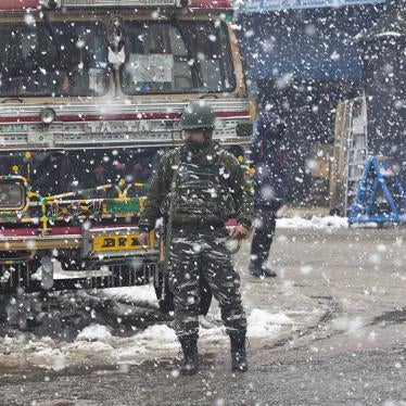 An Indian paramilitary soldier stands guard as snow falls in Srinagar, Kashmir, January 15, 2020.