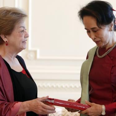 Myanmar's leader Aung San Suu Kyi, right, receives a final report from Philippine diplomat Rosario Manalo, a member of the Independent Commission of Enquiry for Rakhine State, at the Presidential Palace in Naypyitaw, Myanmar, Monday, Jan. 20, 2020. 