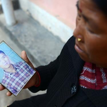 In this photograph taken on February 2, 2017, Nepalese war victim Pabitra Sunakhari shows a photograph of her son as she speaks during an interview with AFP in Birendranagar, Surkhet District, some 520kms west of Kathmandu