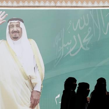 Women walk past a poster of Saudi Arabia's King Salman bin Abdulaziz Al Saud during Janadriyah Cultural Festival on the outskirts of Riyadh, Saudi Arabia February 12, 2018. 