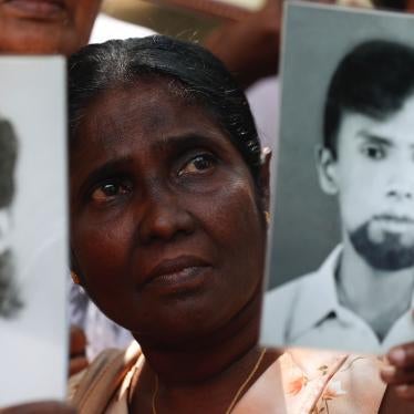 A woman holds a picture of a missing relative at a protest calling for investigations into enforced disappearances, Colombo, Sri Lanka, February 14, 2020.