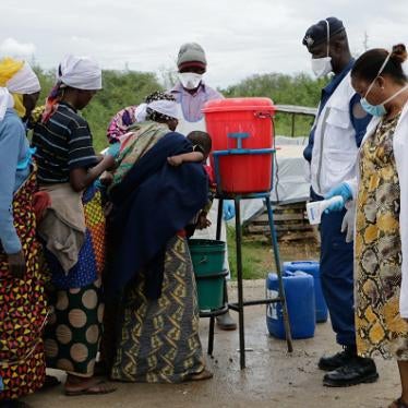 People wash their hands as a preventive measure against COVID-19, on their arrival in Gatumba, Burundi, on the border with the Democratic Republic of Congo, on March 18, 2020.