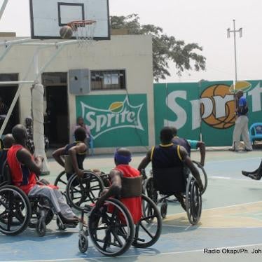 Men in wheelchairs play a game of basketball outside in the Democratic Republic of Congo. 