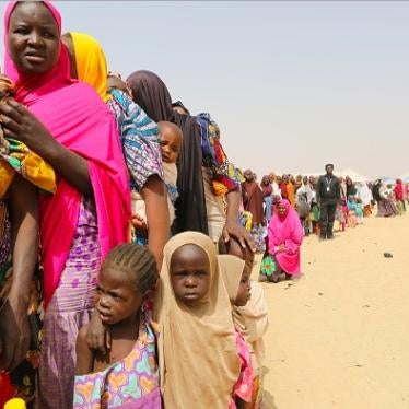 Families displaced by the Boko Haram insurgency line up for food being distributed by International Medical Corps in northeast Nigeria's Borno state on January 29, 2018 in Maiduguri, Nigeria.