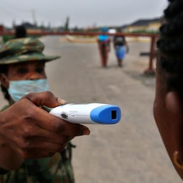 A member of the Nigerian army performs a temperature check on a visitor at the entrance of the Nigerian Army Hospital in the Yaba area of Lagos, Nigeria, February 28, 2020.