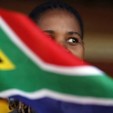 A woman waves a South African flag as she attends Freedom Day celebrations in Kwa-Thema Township, near Johannesburg