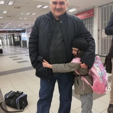 Journalist Afgan Mukhtarli rejoins his daughter in a Berlin airport following his release from prison in Azerbaijan, March 17, 2020.