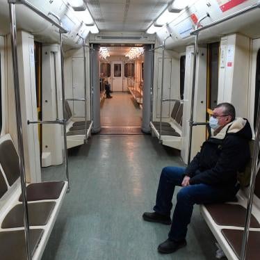 A man wearing a protective face mask rides an empty train on the Moscow Metro, Russia, March 30, 2020.