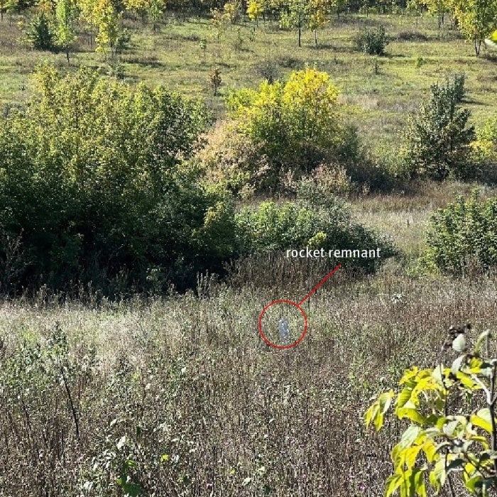 The carrier section of an 9M27K-series Uragan rocket lodged in the ground near a family’s home in Hlynske village, apparently fired from the west, where Ukrainian forces controlled territory while the area was under Russian occupation in 2022.  Each rocket delivers 30 9N210 or 9N235 submunitions.