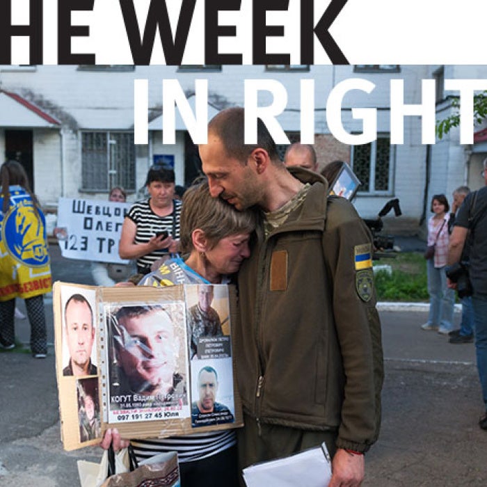 Protesters hold signs in Ukraine. 